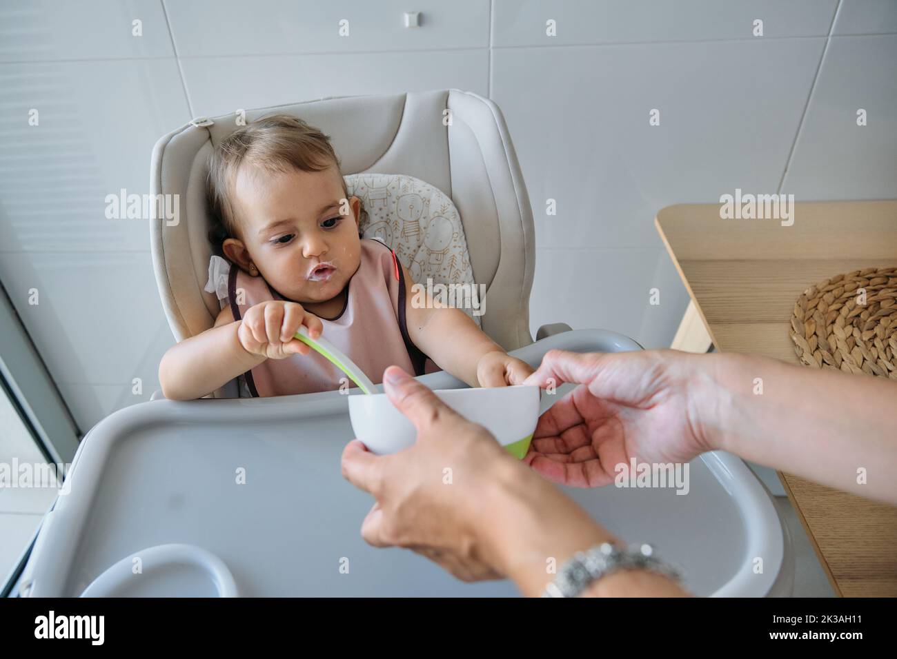 Woman help mother feed baby hi-res stock photography and images - Alamy