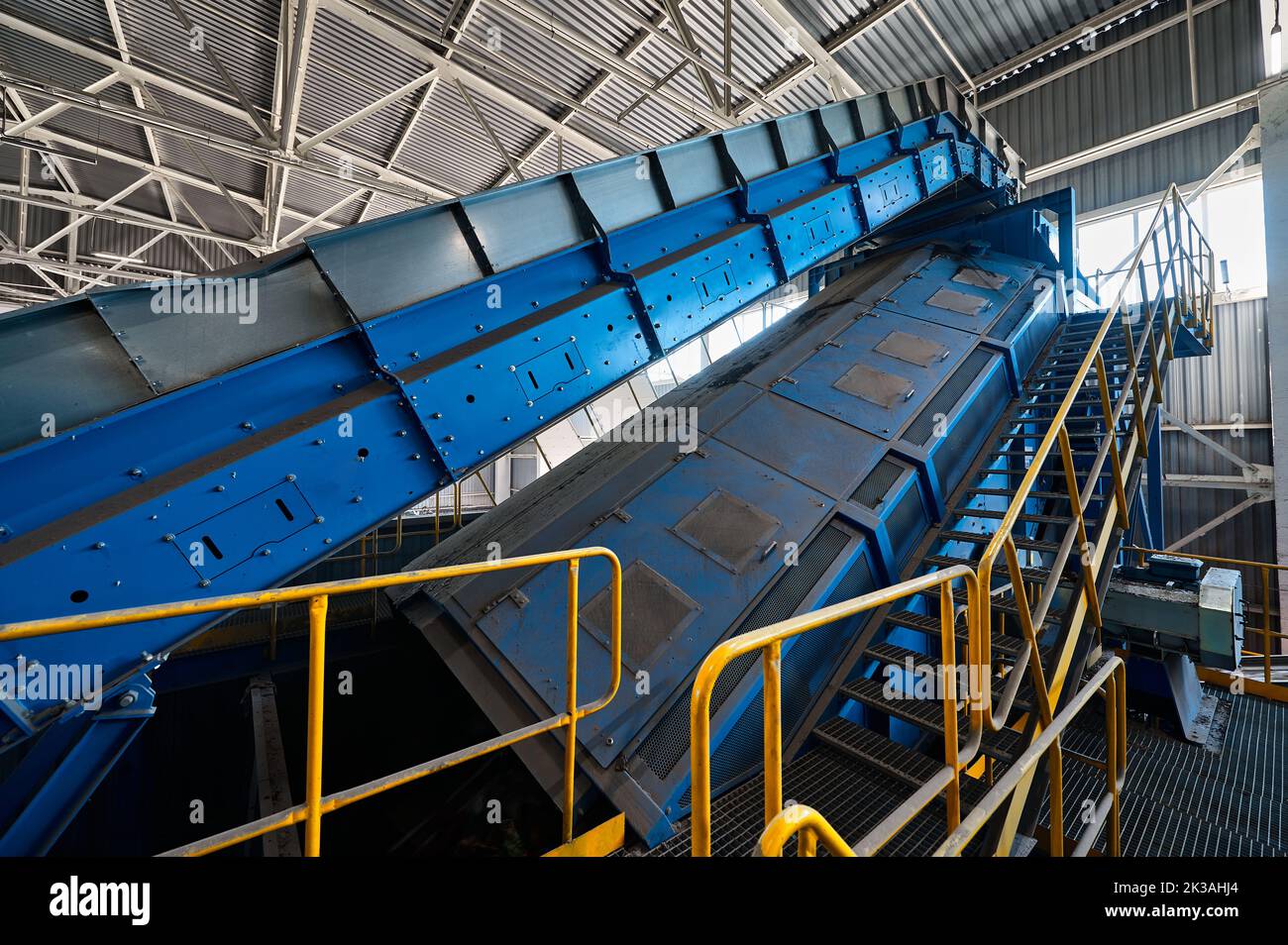 Large production line with conveyors carrying trash at plant Stock Photo