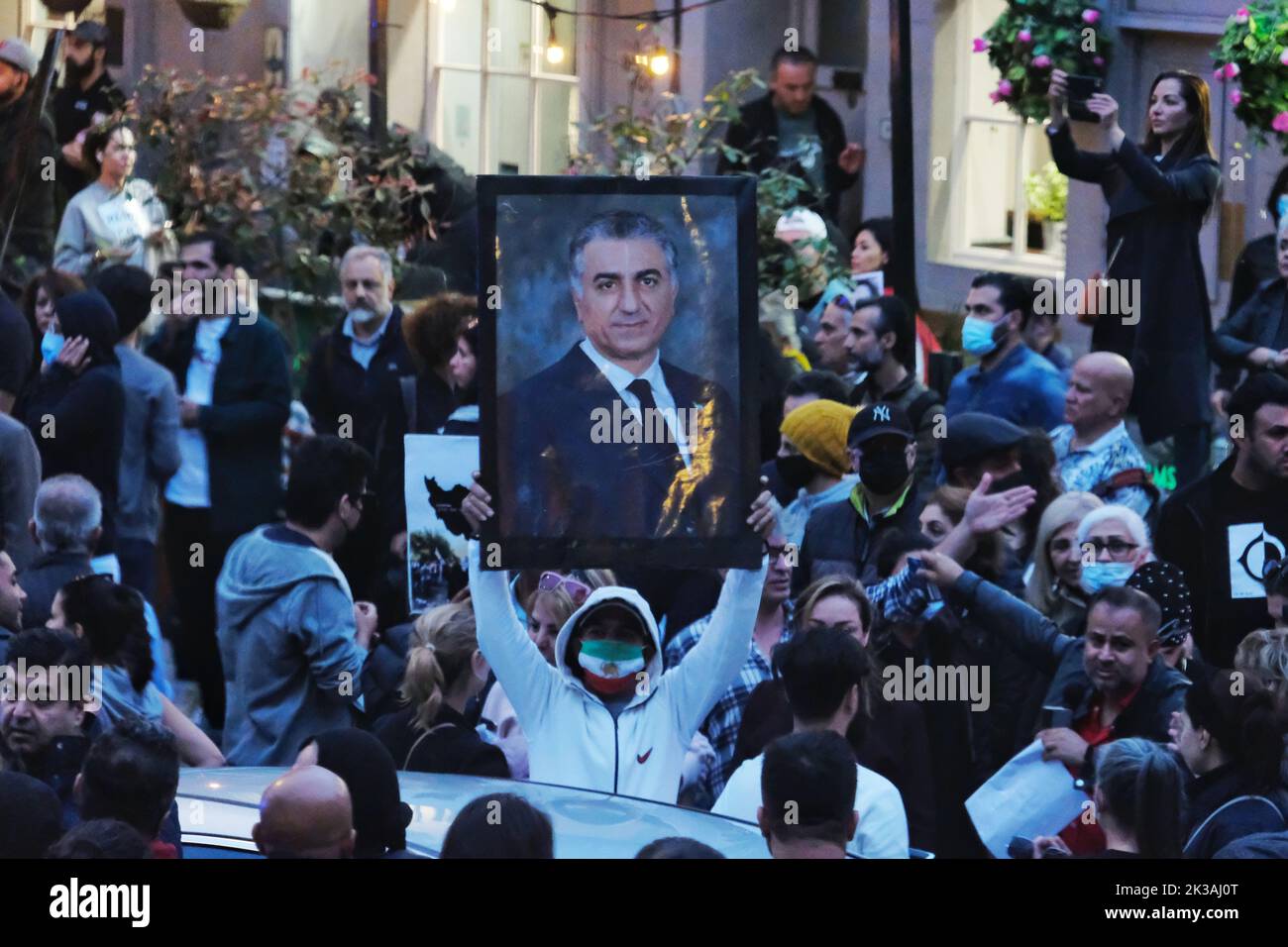 London, UK. 25th September, 2022. A man holds up a portrait of the Shah of Iran. Hundreds of British-Iranians continued their protest after a 22-year-old Kurdish woman Mahsa Amini detained by the nation's morality police for wearing her hijab incorrectly, died in custody. A demonstration that begun outside the Iranian Embassy moved to the Islamic Centre of England who is run by the UK representative of Ayotollah Khamenei. Riot police were drafted in to disperse the crowd after disorder broke out. Credit: Eleventh Hour Photography/Alamy Live News Stock Photo