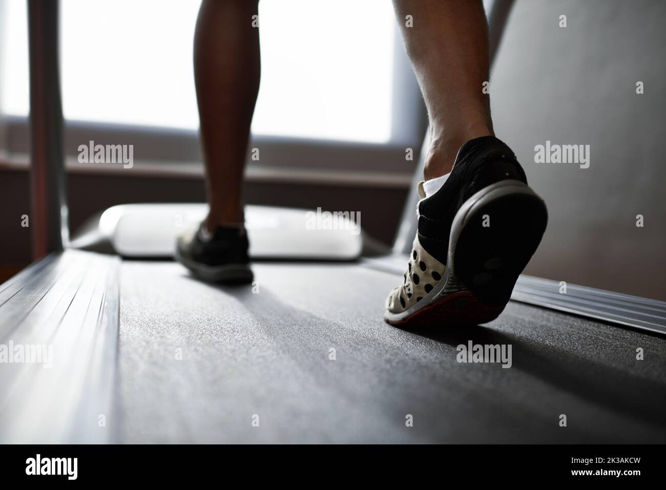 Running those calories off. Closeup shot of a man on a treadmill at the gym. Stock Photo