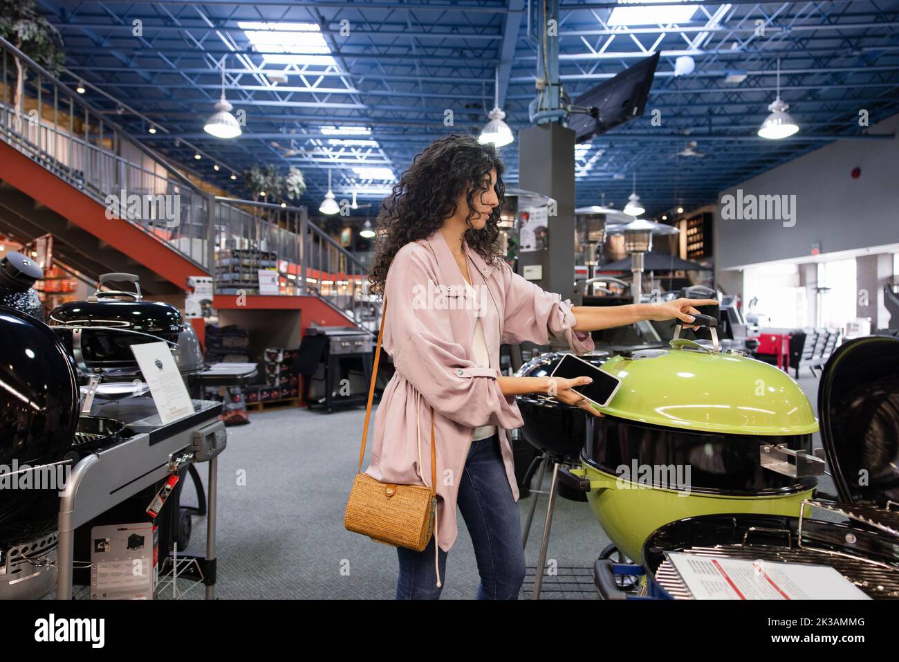 Customer browsing barbeque grill in store Stock Photo Alamy