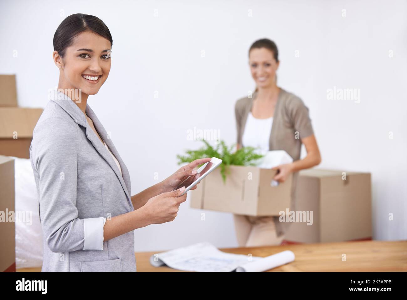 Moving into our new office. Two young female colleagues moving into