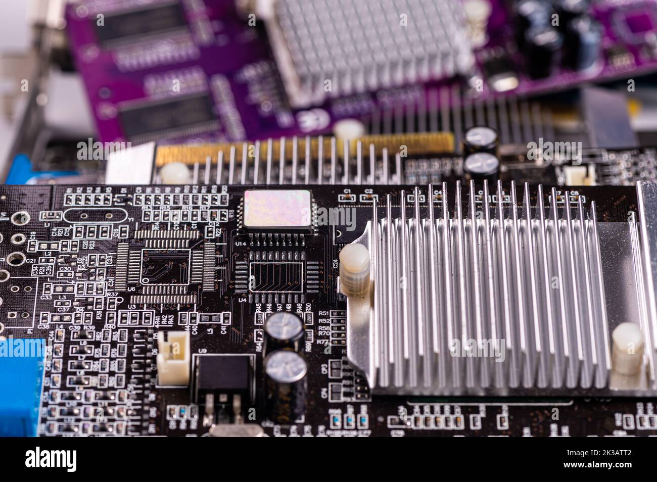 electronic circuit and cooling fin at computer video card, stack with used video cards, close-up Stock Photo