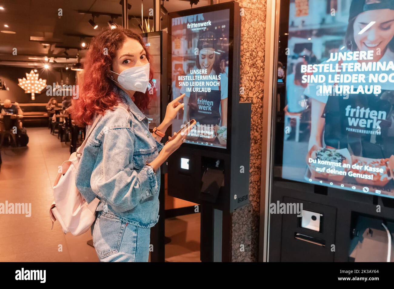 21 July 2022, Dusseldorf, Germany Woman customer wearing face mask