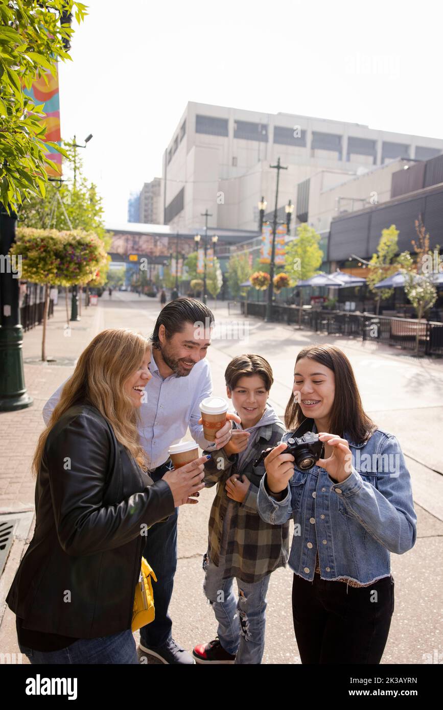 Happy family with digital camera enjoying city break Stock Photo