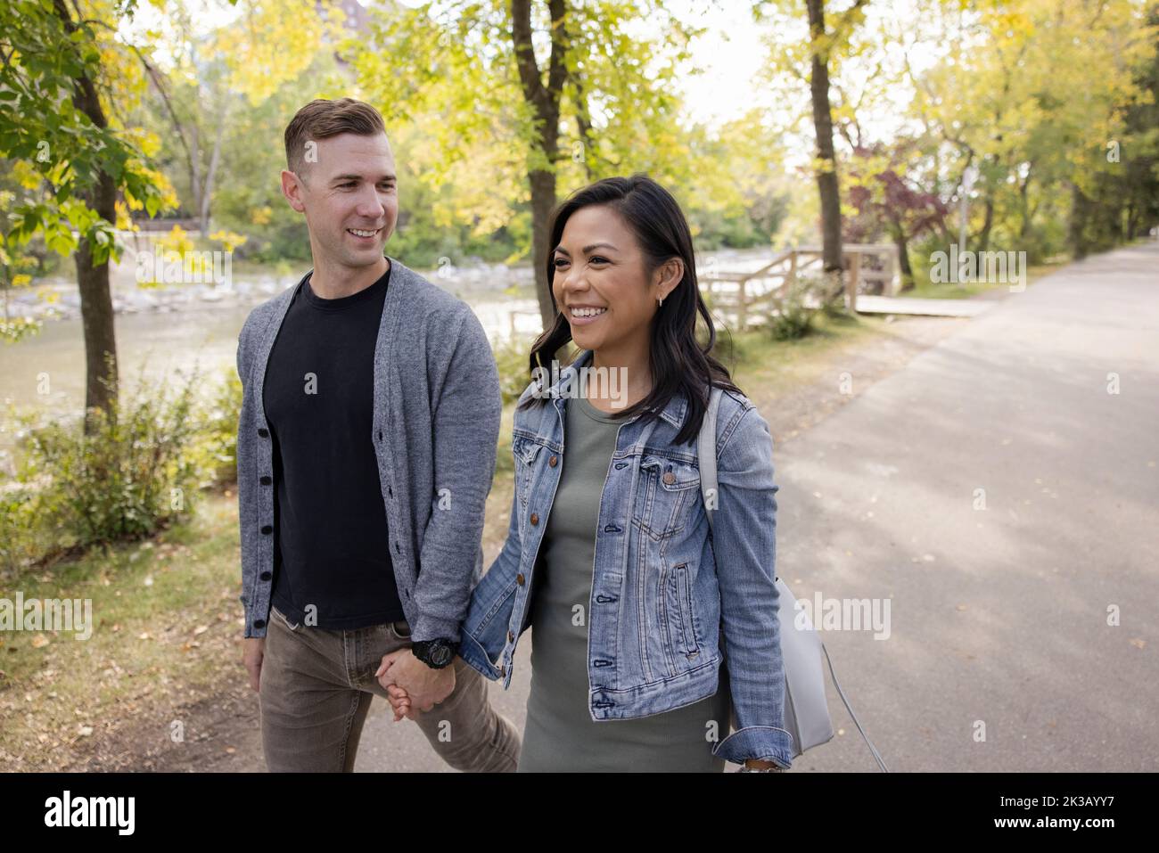 Asian couple holding hands walking hi-res stock photography and images ...