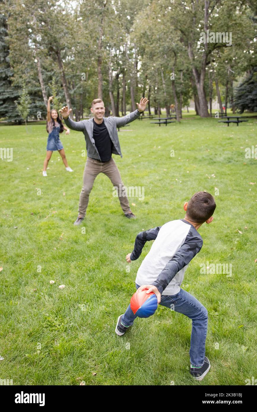 Boy playing football park hi-res stock photography and images - Alamy