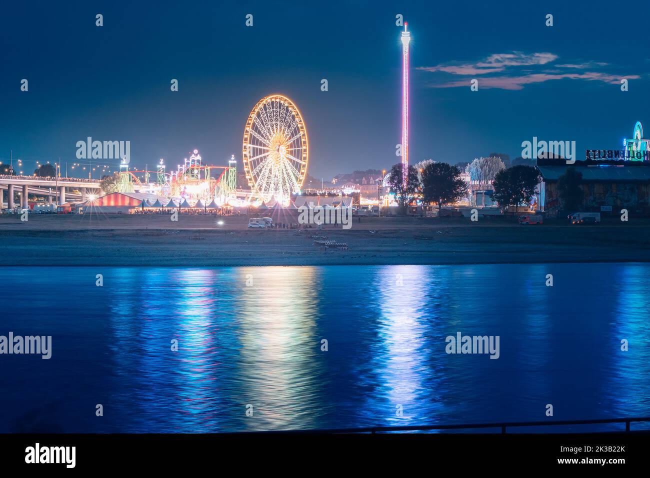 22 July 2022, Dusseldorf, Germany Evening view of fair festival and amusement park at a