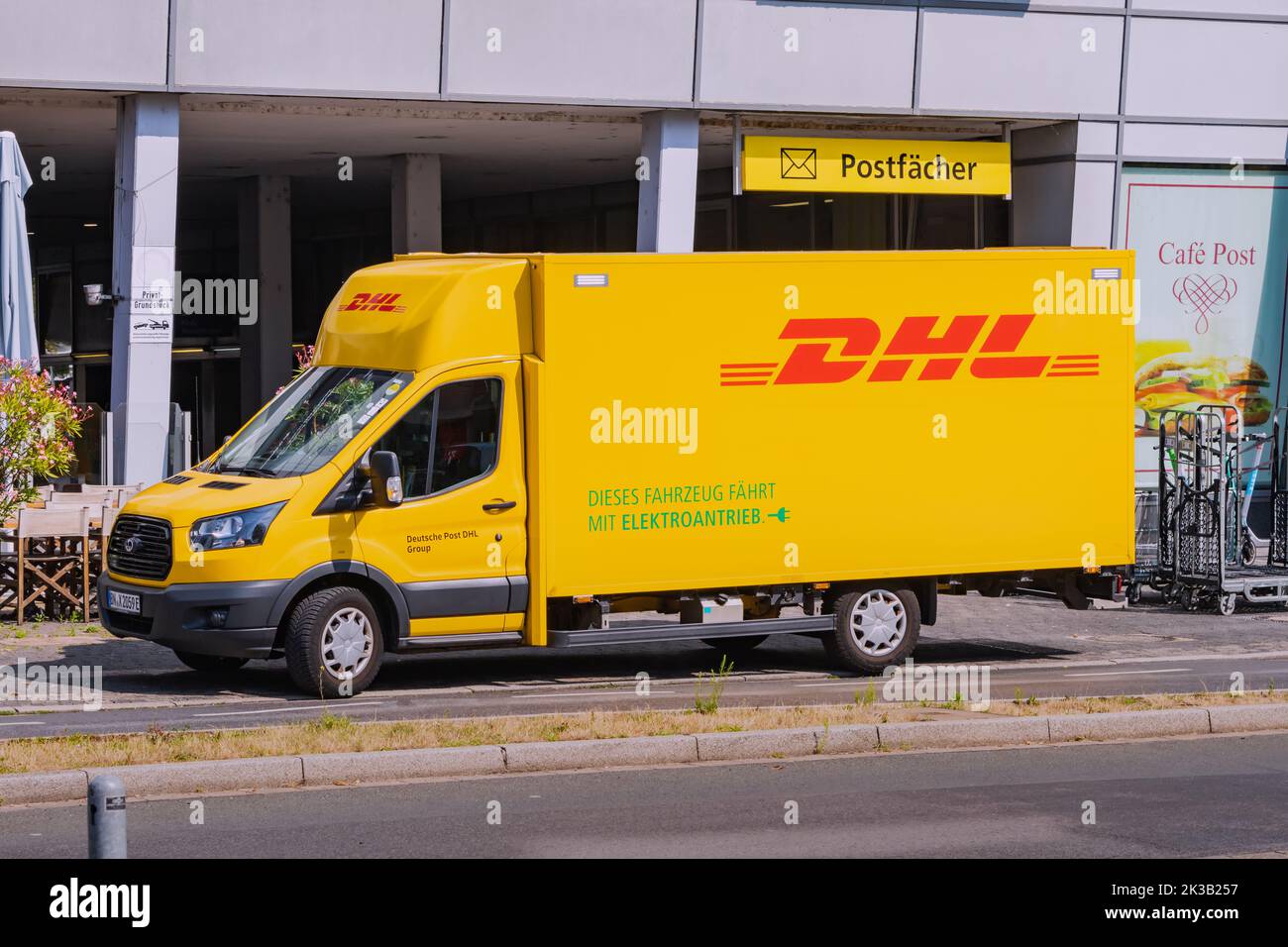 23 July 2022, Dusseldorf, Germany: DHL delivery truck near german post warehouse. Shipping and cargo transportation industry Stock Photo