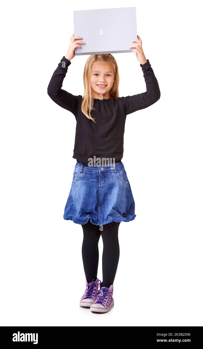 Look at what Ive got. Studio shot of a young girl holding up a blank sign for copyspace. Stock Photo