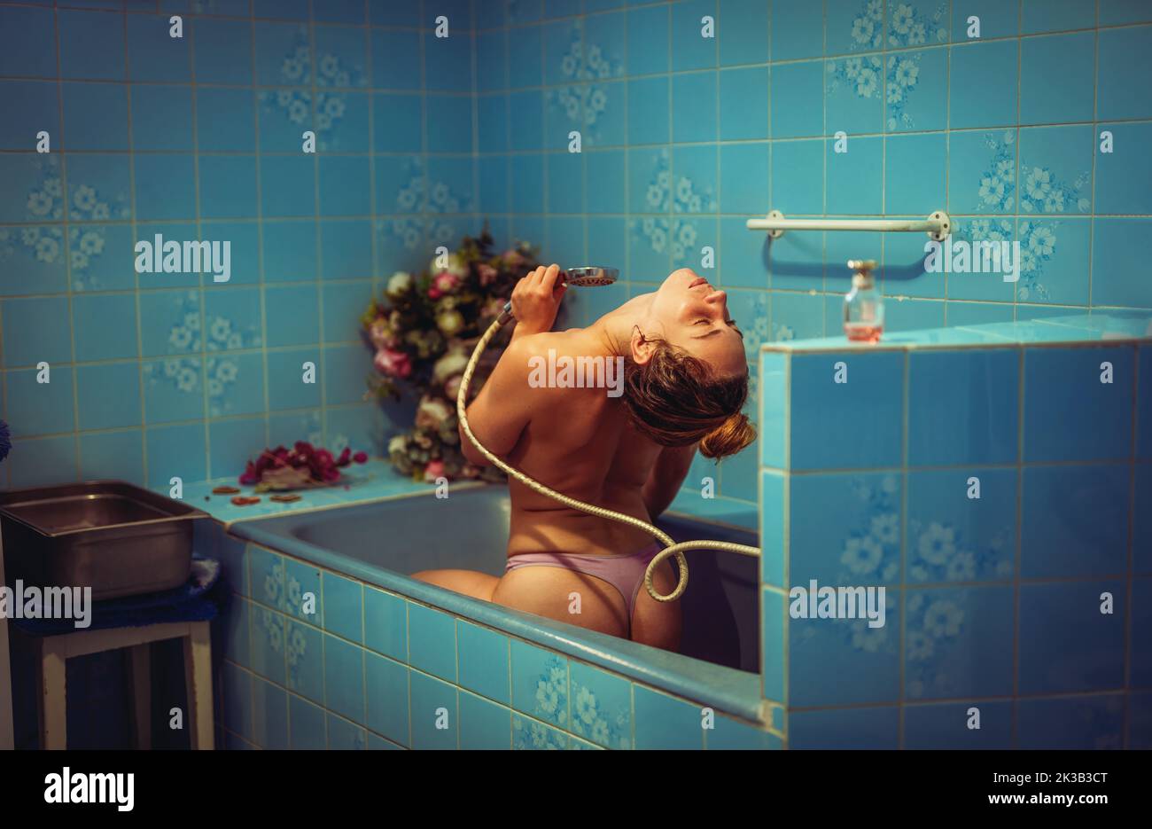Woman taking a bath. View from behind. Stock Photo