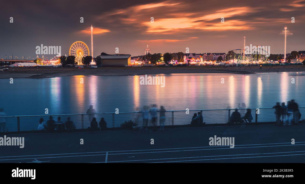 22 July 2022, Dusseldorf, Germany Evening view of fair festival and amusement park at a