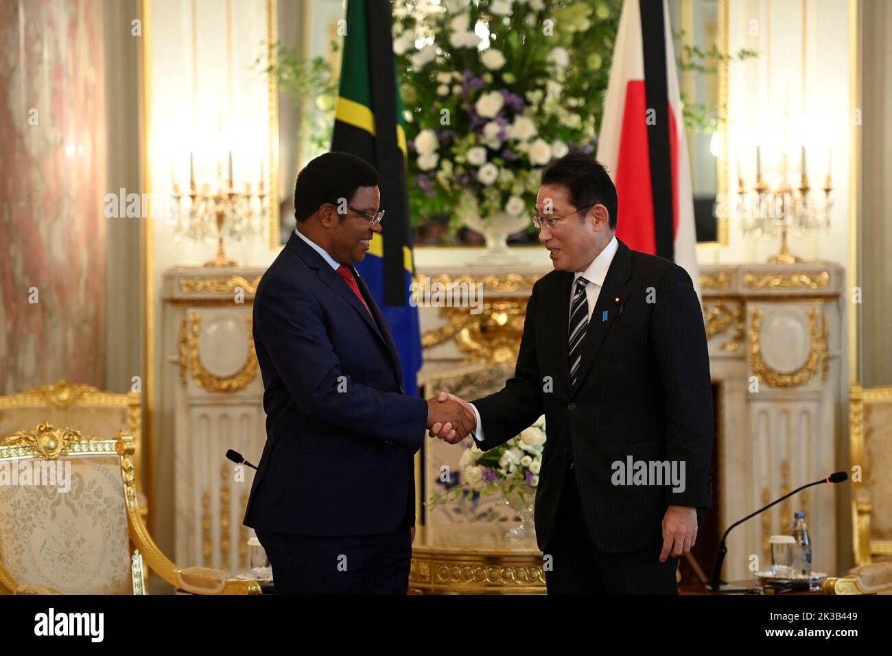 Prime Minister Kassim Majaliwa of United Republic of Tanzania and Japan's Prime Minister Fumio Kishida shake hands as they pose for photographers prior to the Japan-Tanzania summit meeting at Akasaka Palace State Guest House in Tokyo, Japan on September 26, 2022 in Tokyo, Japan.  David Mareuil/Pool via REUTERS Stock Photo