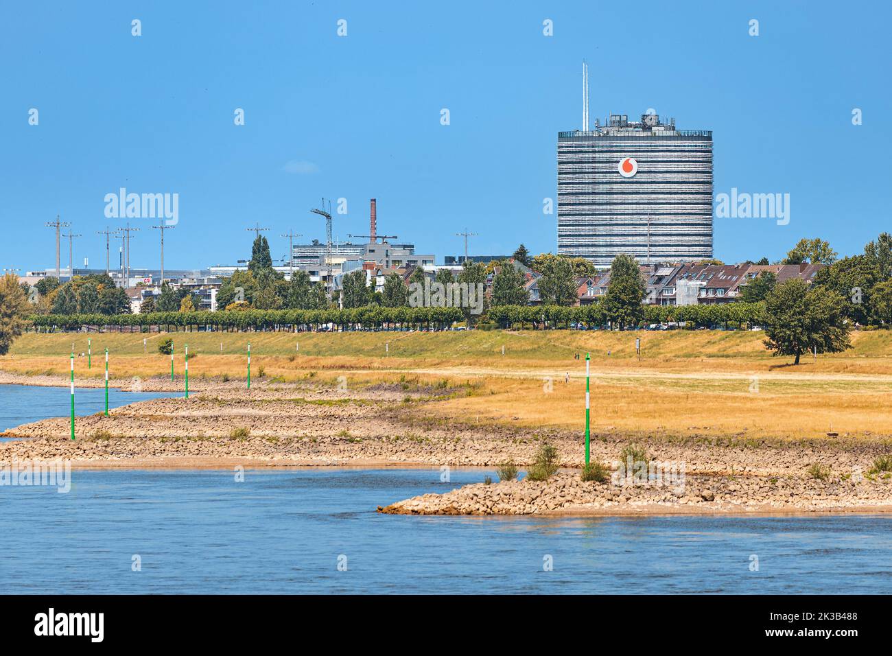 23 July 2022, Dusseldorf, Germany: Industrial area with chemicals plants and factories in city suburbs. Rhine river in the foreground. Stock Photo