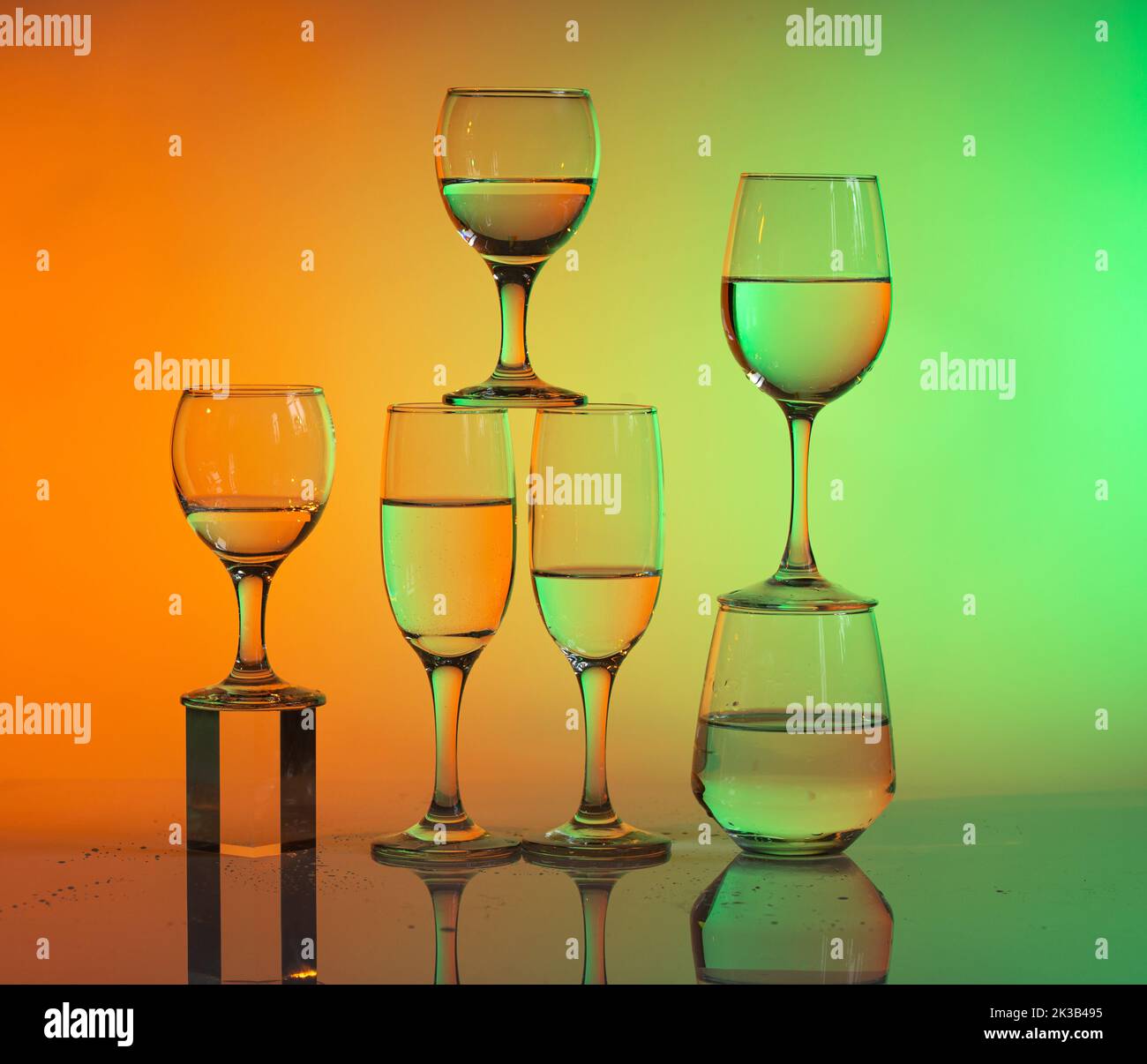 Wine glasses with neon multicolor light Stock Photo