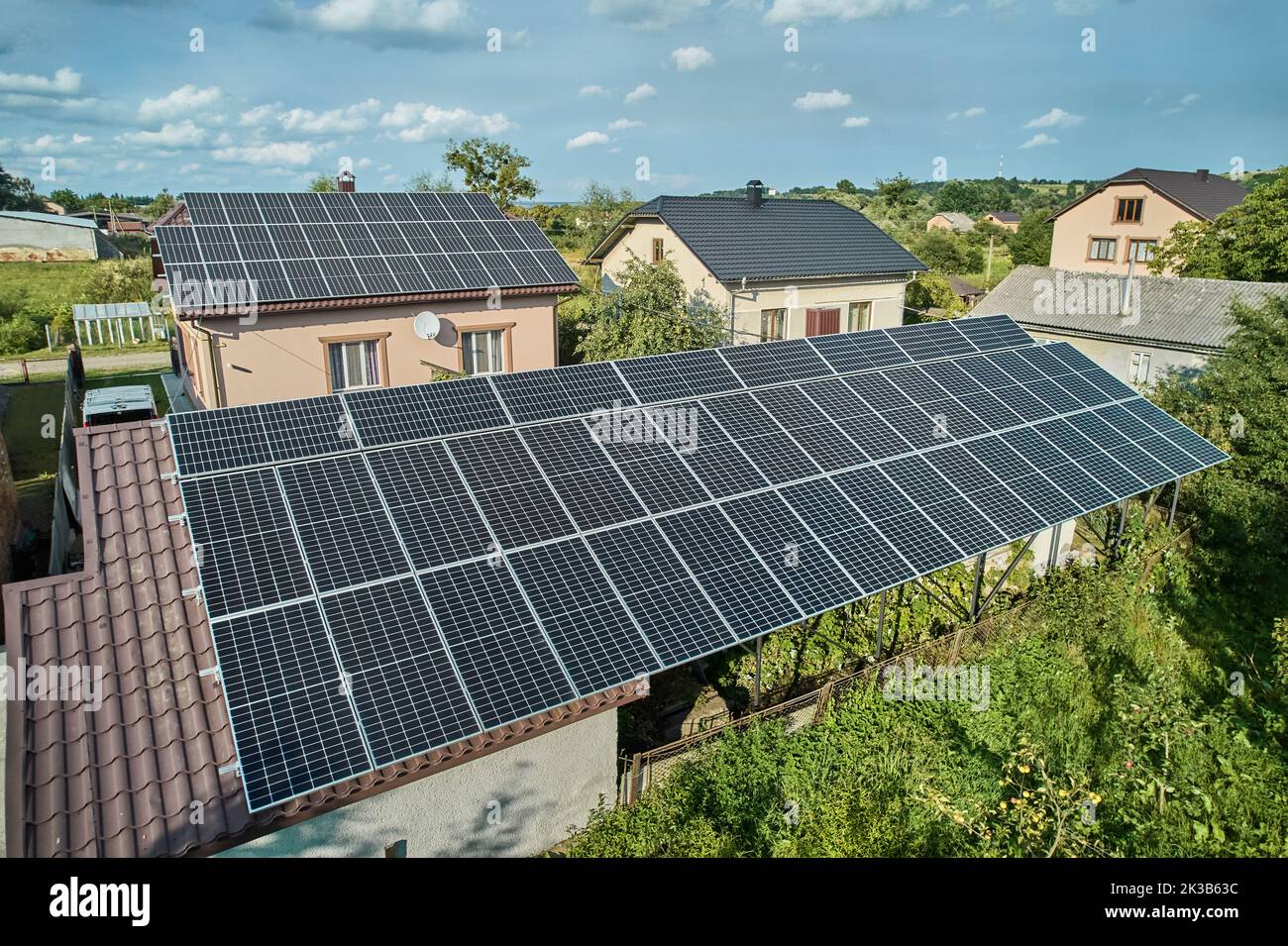 Aerial top view of new modern house cottage with solar photovoltaic