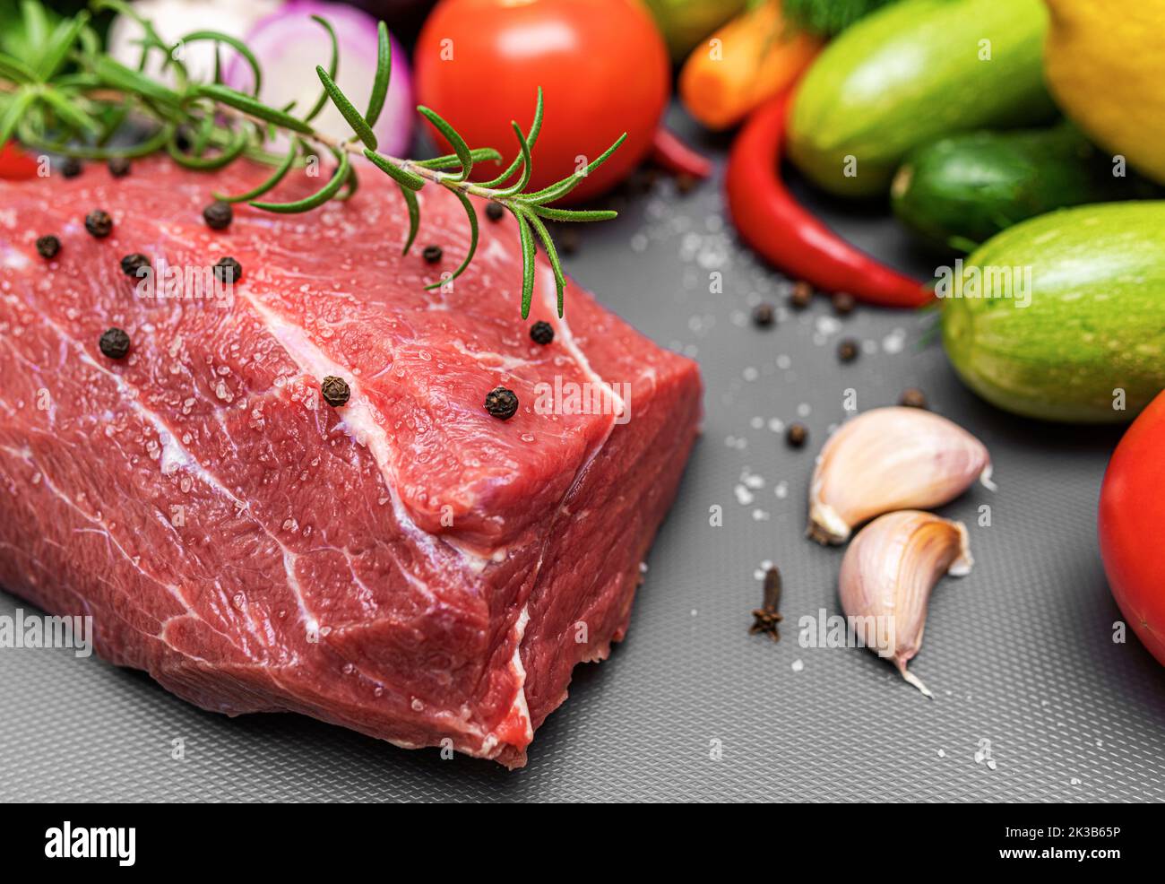 A piece of raw meat on a cutting board. Stock Photo