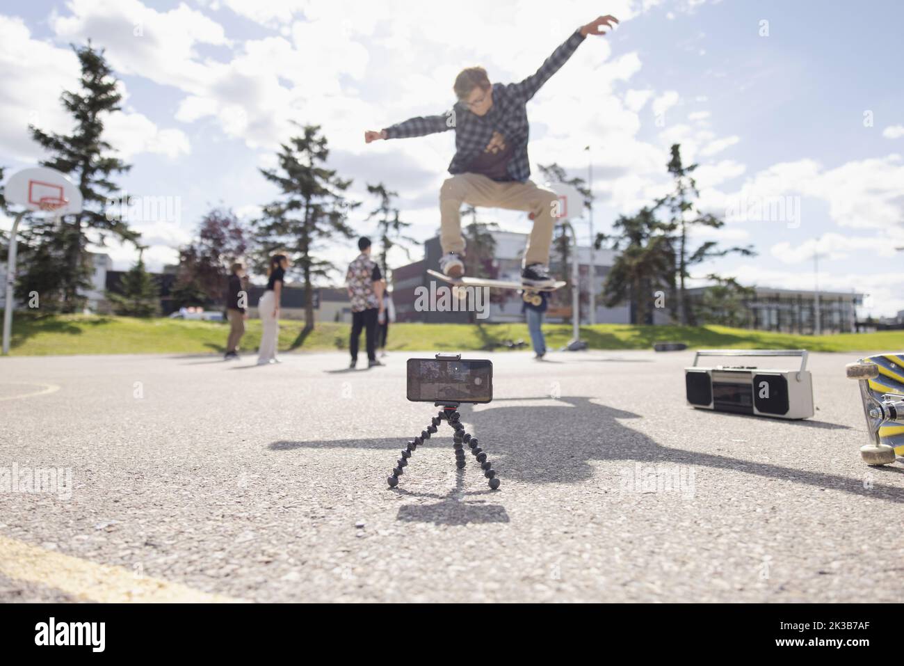Teen boy making skateboarding video in basketball court Stock Photo Alamy Teen boy making skateboarding video in basketball court Stock Photo Alamy