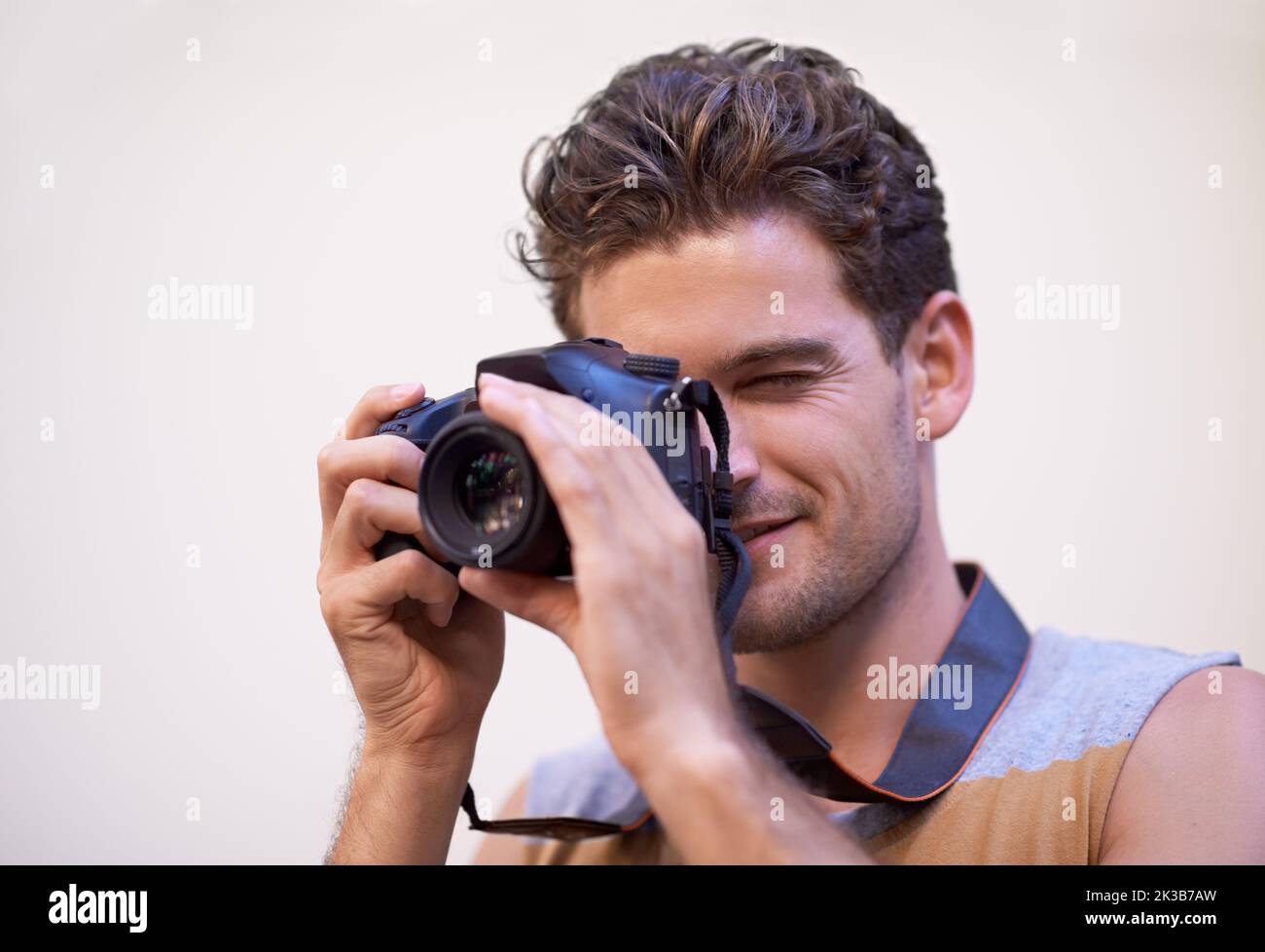 Photography is my favorite pastime. a young man taking a photograph outside. Stock Photo
