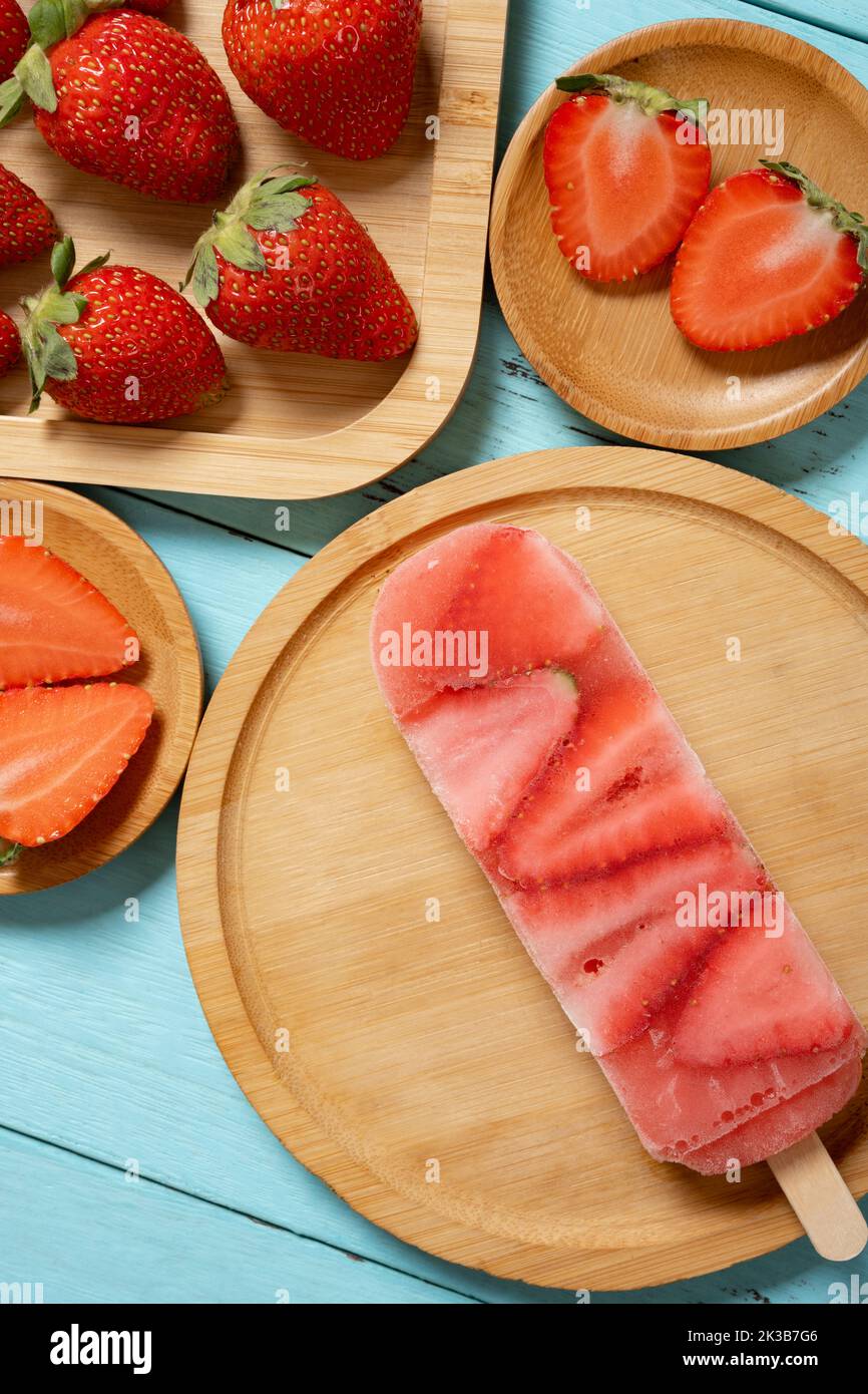 top view strawberry slices popsicle with fresh strawberries vertical composition Stock Photo