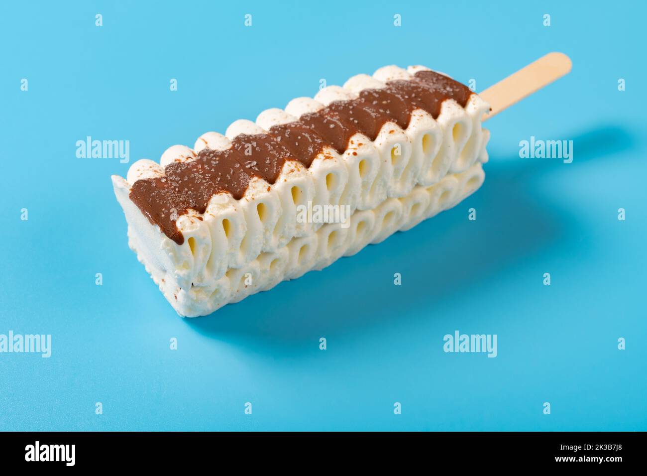 angle view vanilla and chocolate flavor popsicle on a blue background Stock Photo