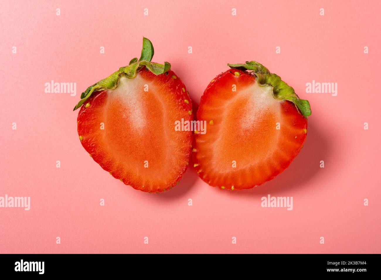 fresh cut out strawberry on pink background Stock Photo