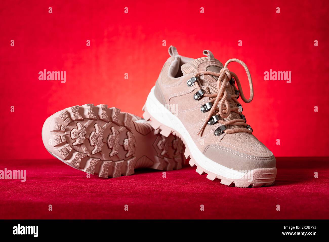pink color hiking boots for lady on red Stock Photo