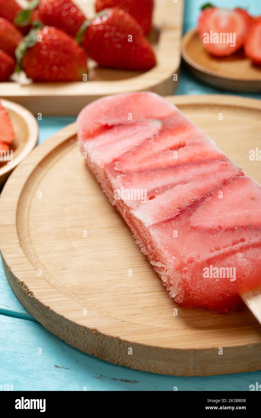angle view strawberry slices popsicle with fresh strawberries vertical composition Stock Photo