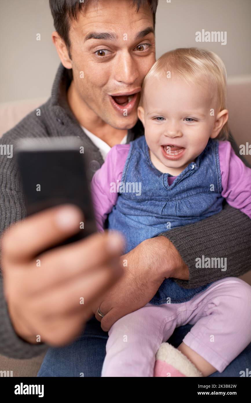 Lets make silly faces for this one. A father taking a self-portrait of himself and his baby girl. Stock Photo
