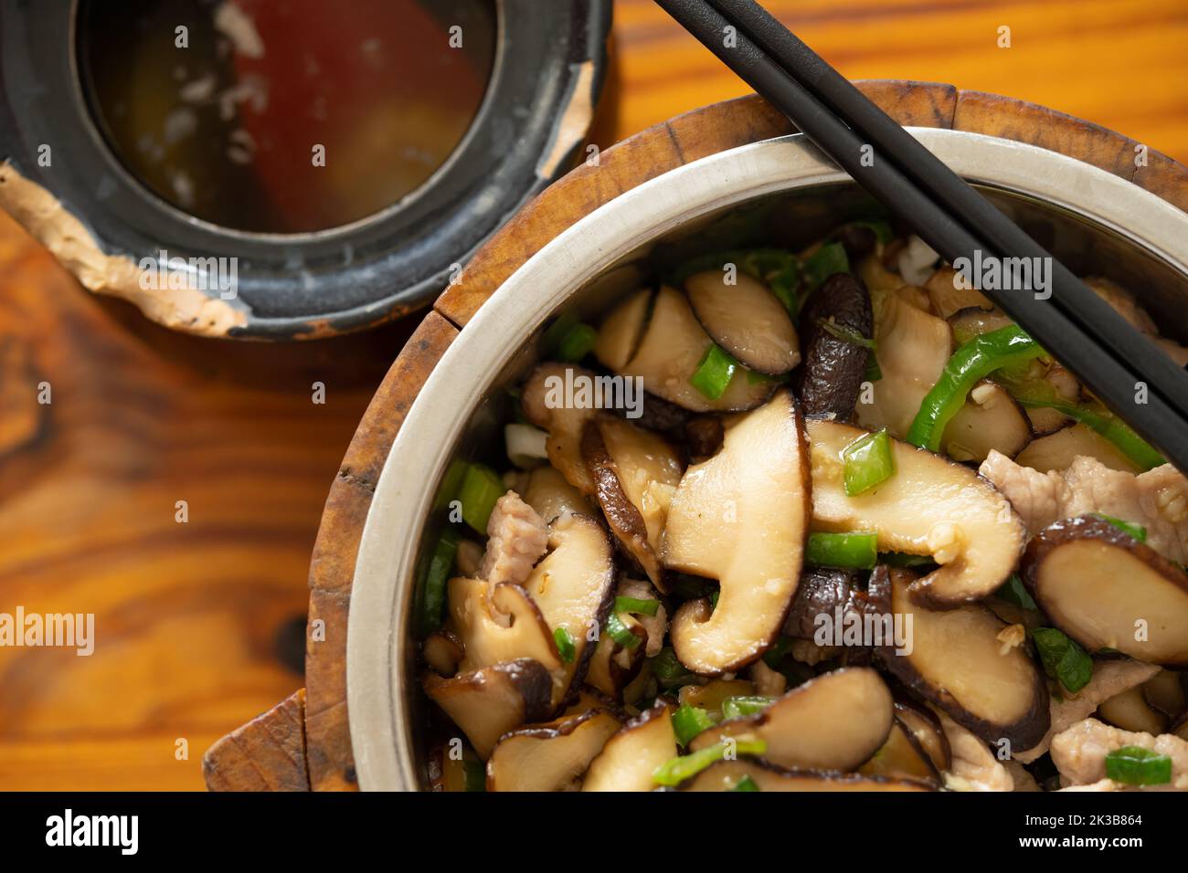 top view fast food of fried pork with slices of mushrooms with bowl of soup at horizontal composition Stock Photo