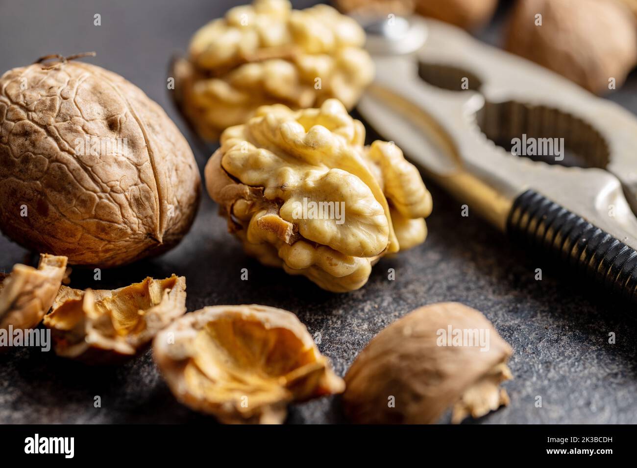 Peeled walnut on the dark table. Stock Photo