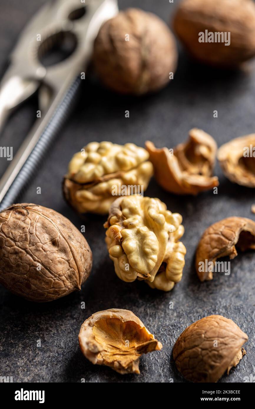 Peeled walnut on the dark table. Stock Photo