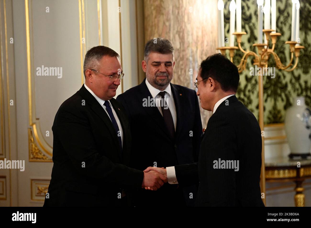 Romanian Prime Minister Nicolae Ionel Ciuca (L), Romanian House of Representatives Speaker Marcel Ciolacu (C) are welcomed by Japan's Prime Minister Fumio Kishida (R) prior to the Japan-Romania Summit Meeting at Akasaka Palace State Guest House in Tokyo, Japan on September 26, 2022 in Tokyo, Japan.  David Mareuil/Pool via REUTERS Stock Photo