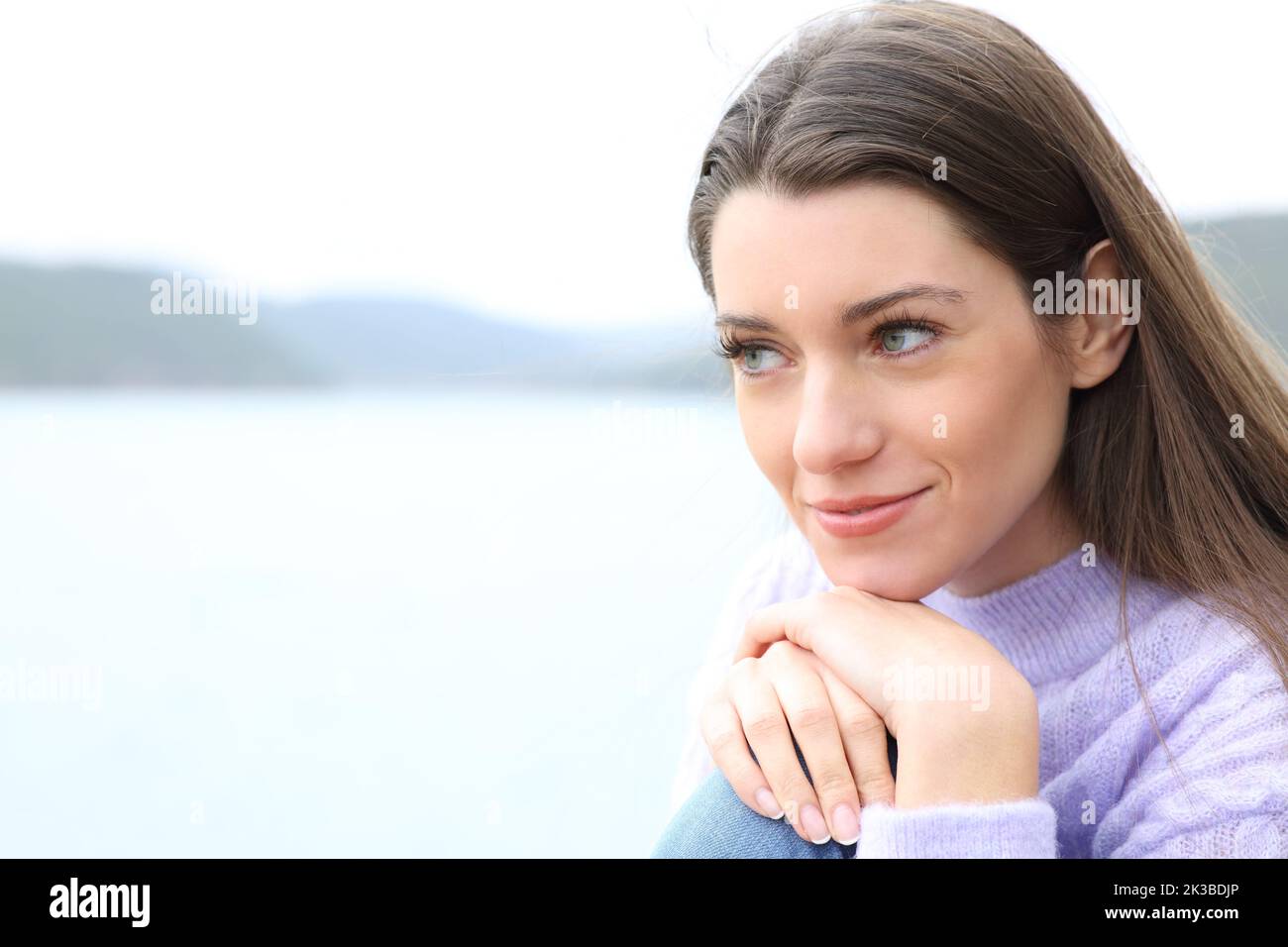 Confident woman relaxing and contemplating nature Stock Photo