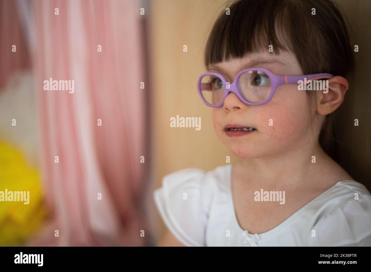 Little girl with down syndrome at ballet class in dance studio. Concept of integration and education of disabled children. Stock Photo