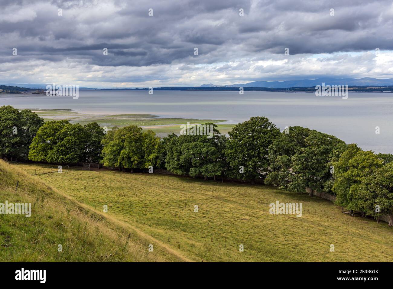 View inland along the Forth River in Scotland, with Blackness Castle in the distance. Stock Photo