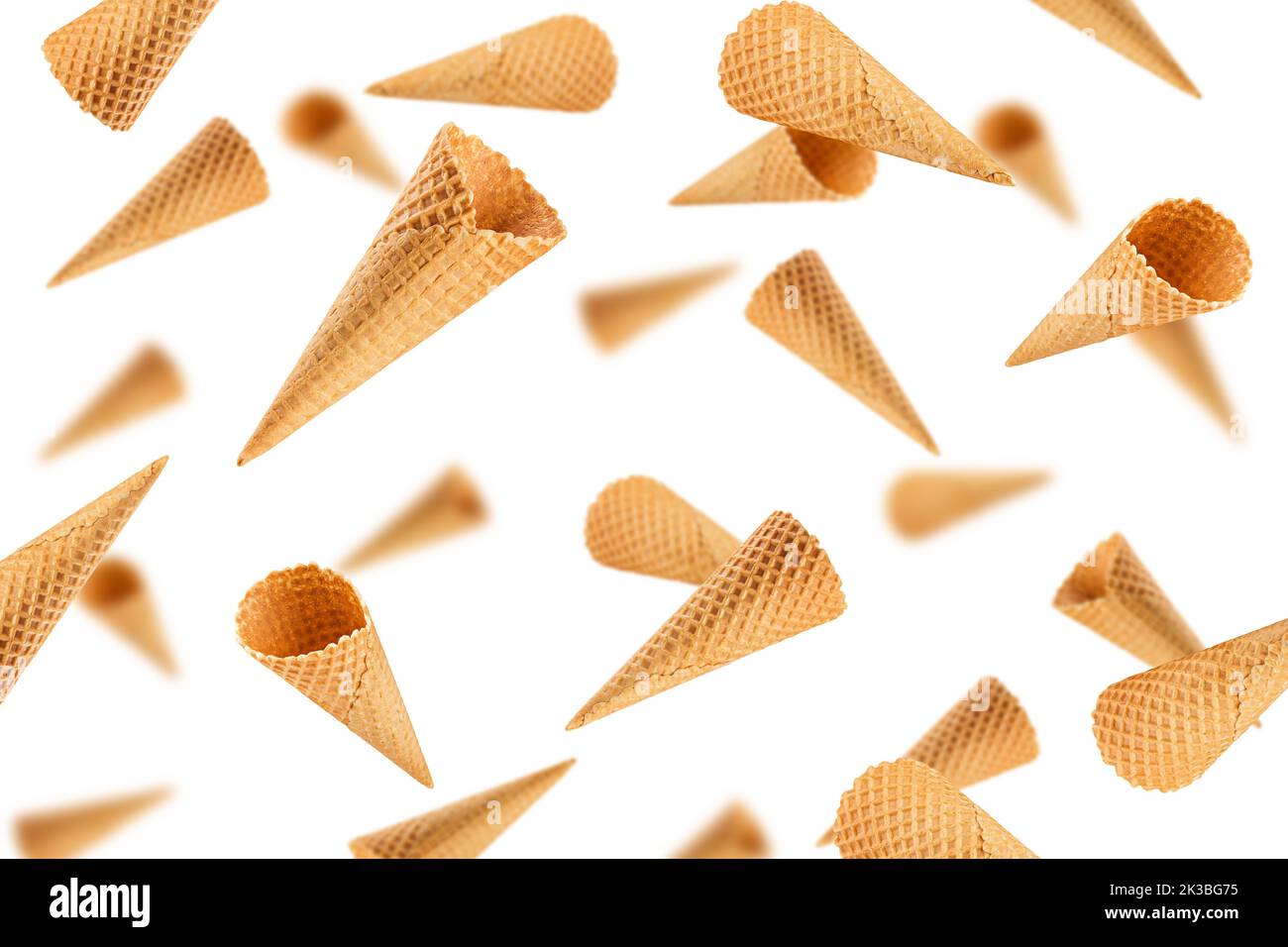 Falling Empty ice cream cone, isolated on white background, selective focus Stock Photo