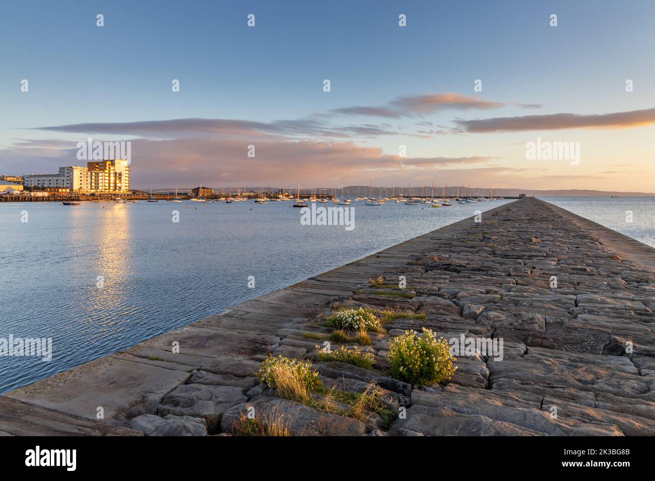 Sunrise at the stone breakwater at Granton harbour, Wardie Bay, in Edinburgh, Scotland. Stock Photo