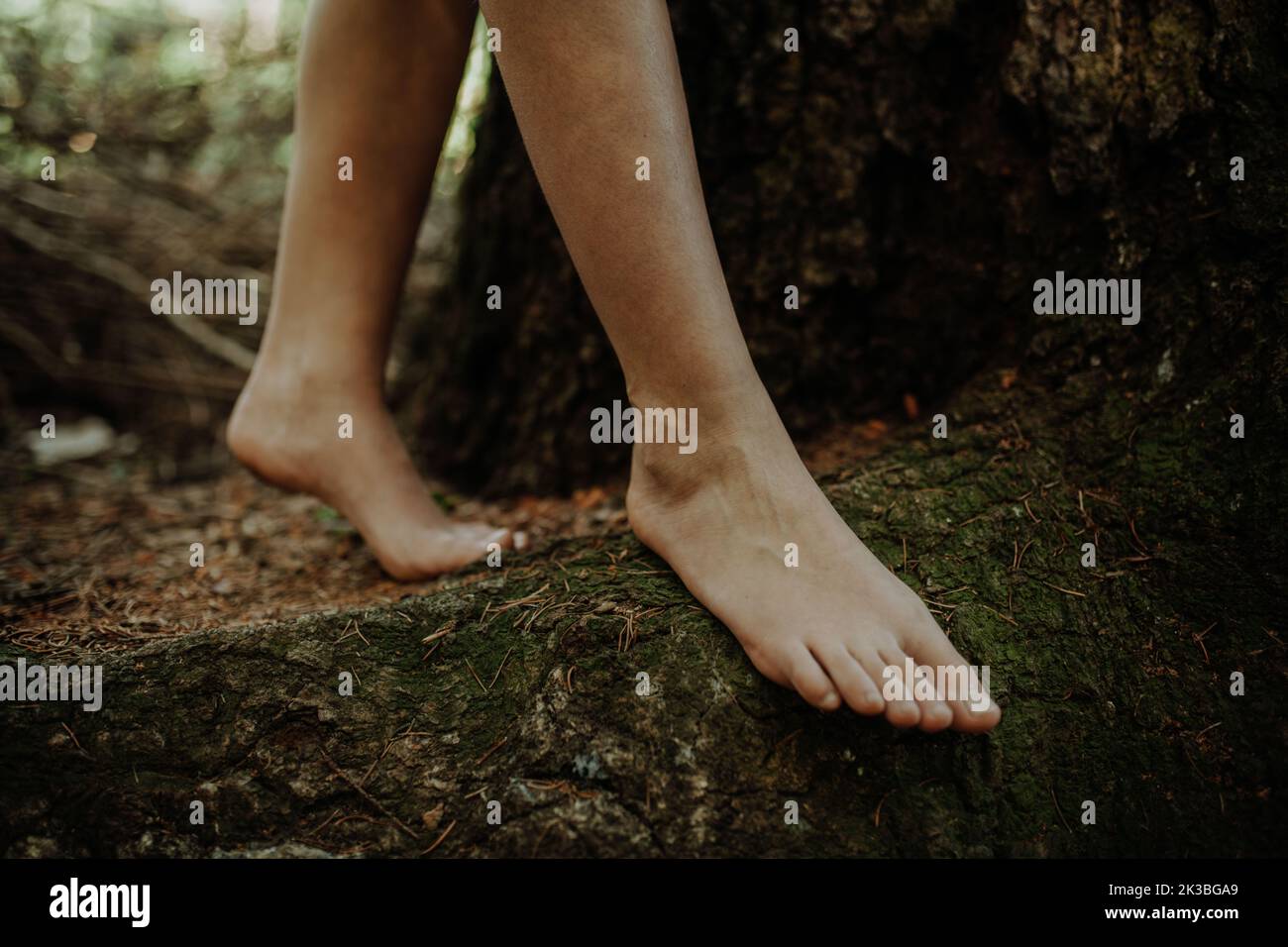 Close-up of barefoot legs walking in nature. Concept of healthy feet. Stock Photo