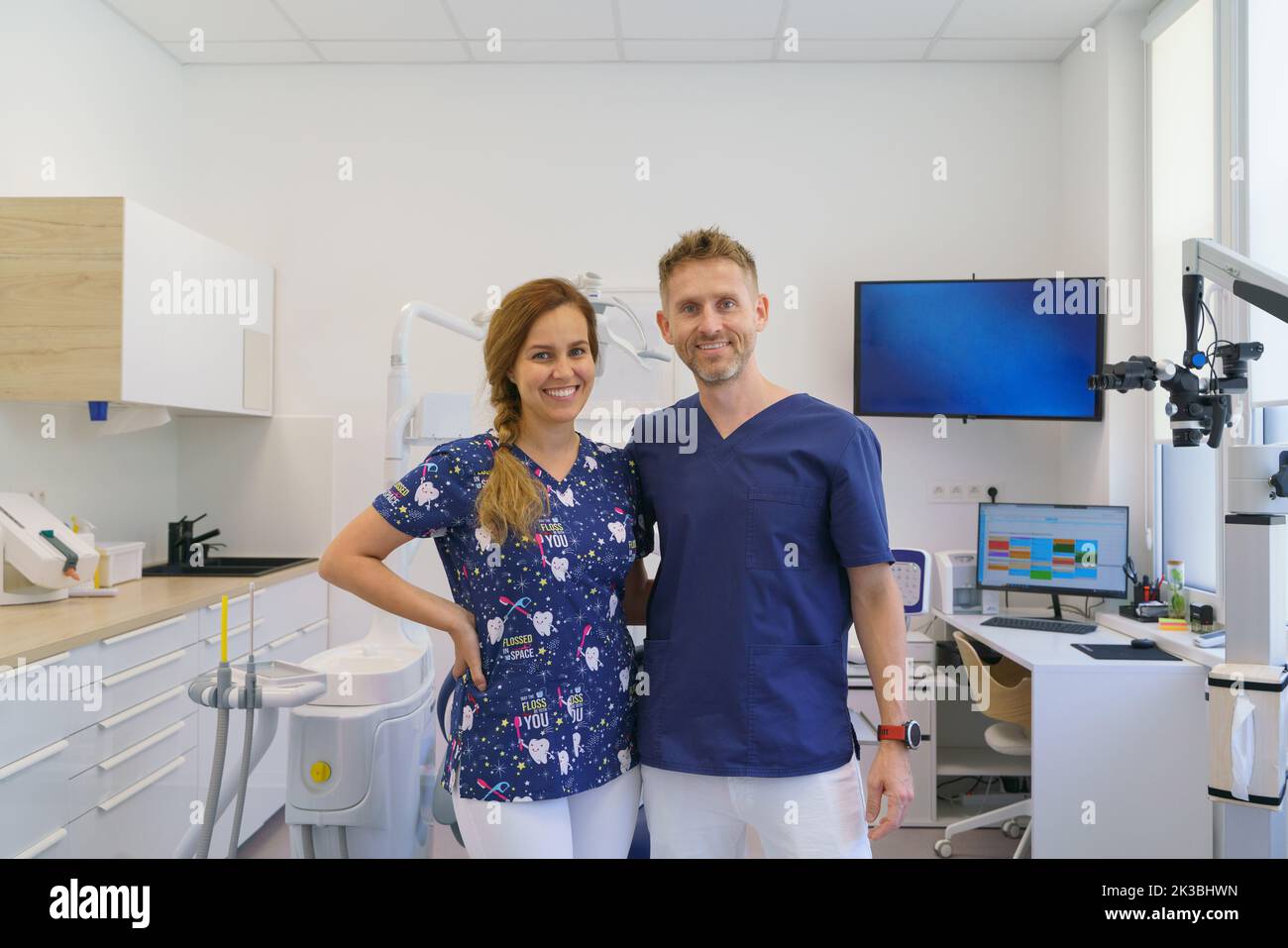 Dentist posing with nurse in dentists ambulance. Stock Photo