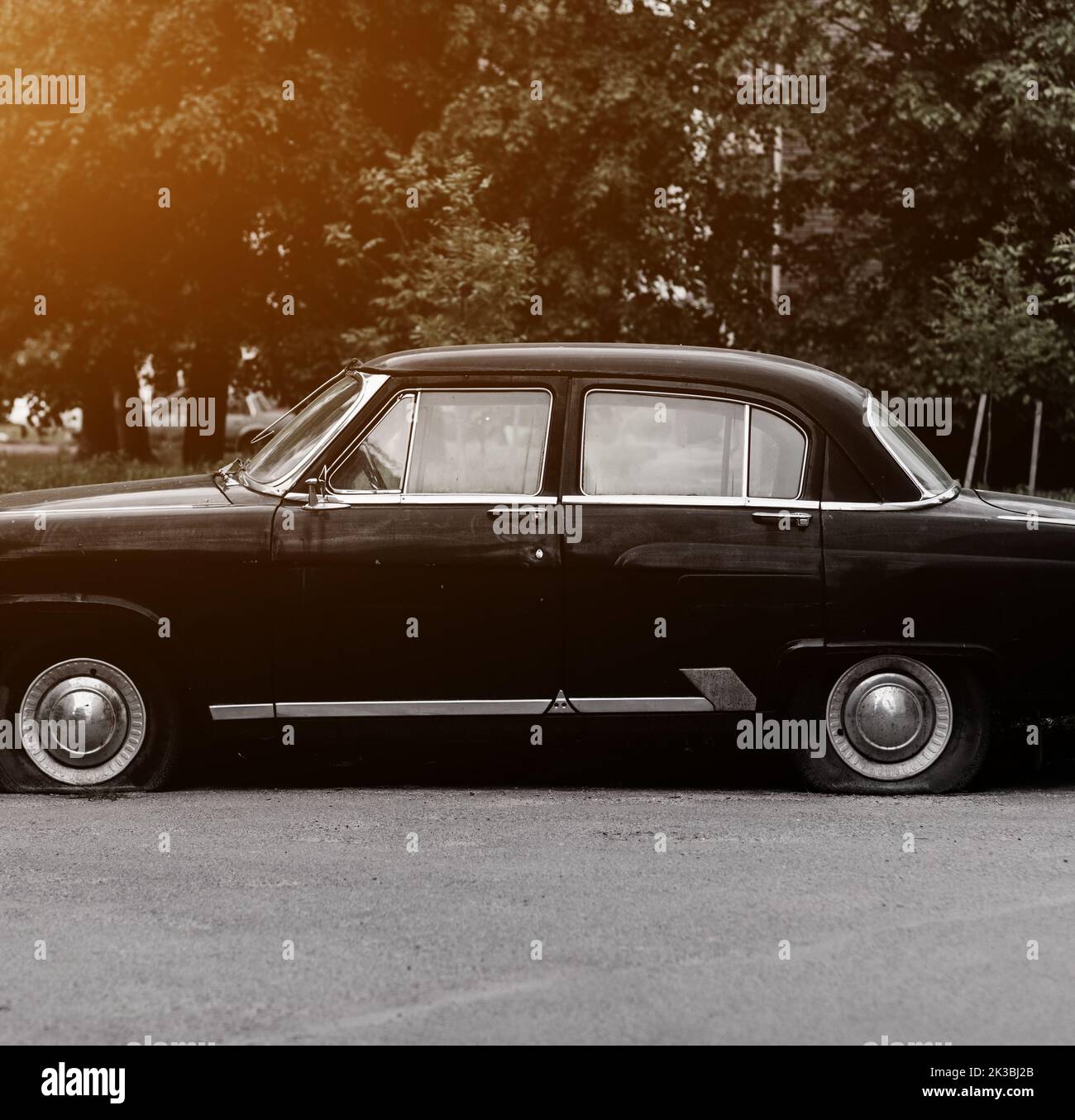 Deflated Car old black vintage car with deflated wheels Stock Photo - Alamy
