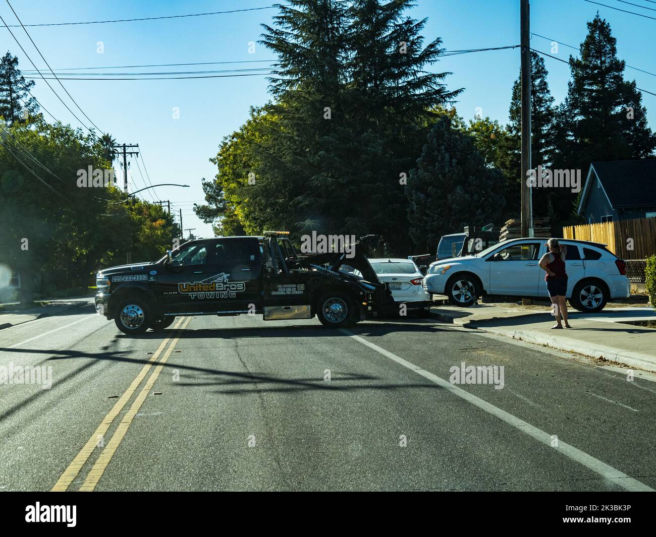 A tow truck drops off a disabled vehicle at a customers home in Modesto California USA Stock Photo