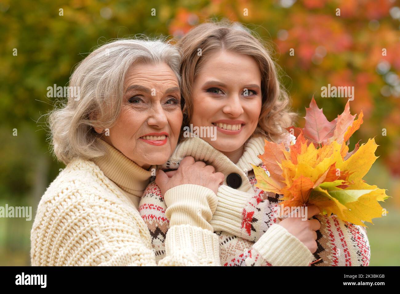 Portrait of an elderly woman with her daughter in the park in autumn. Stock Photo