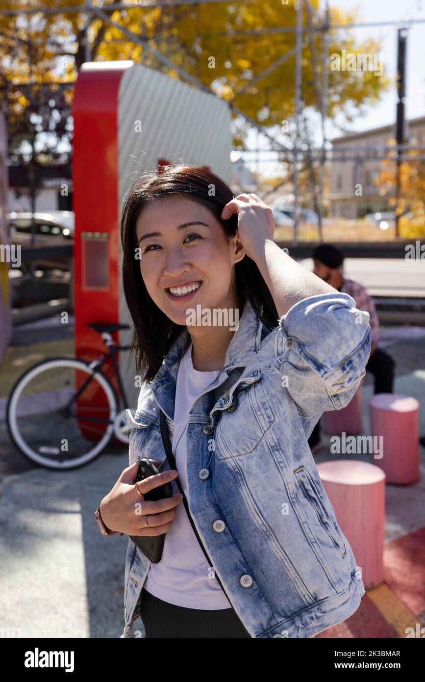 Portrait happy beautiful young woman in denim jacket Stock Photo