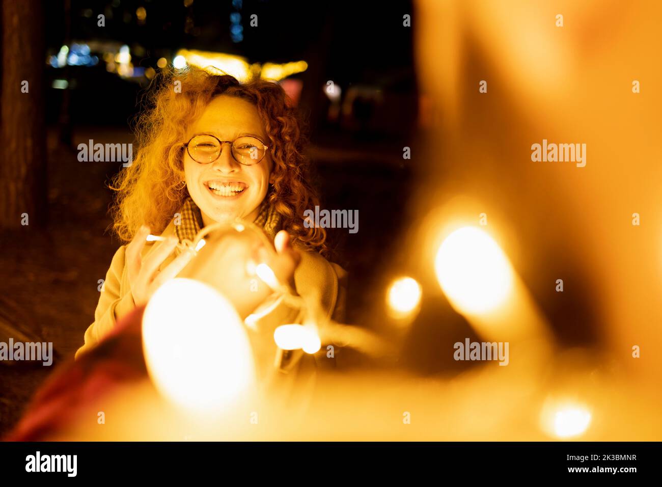 Young Caucasian woman under night lights Stock Photo