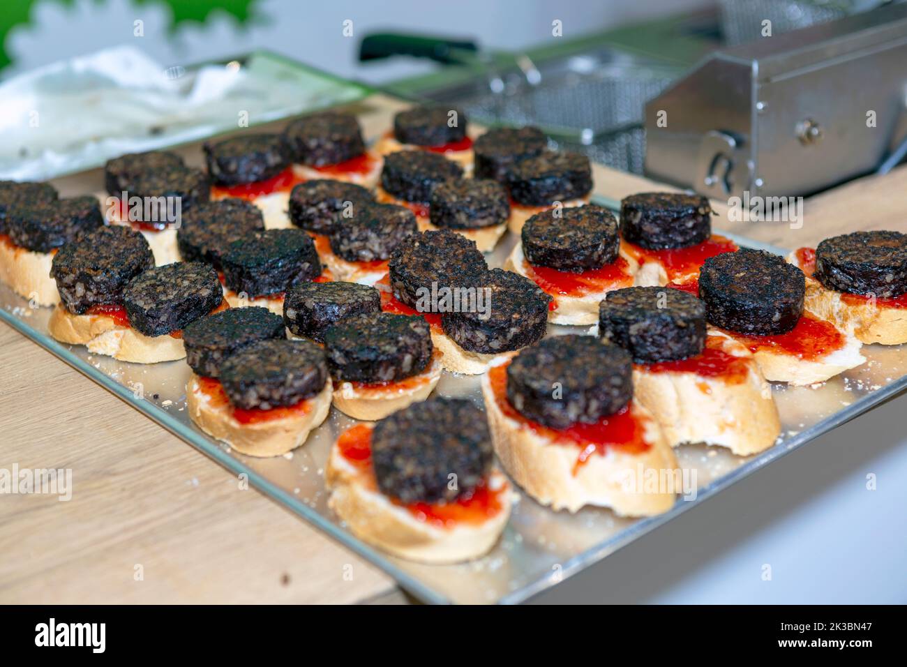 tray of typical Spanish tapas with blood sausage on a slice of bread