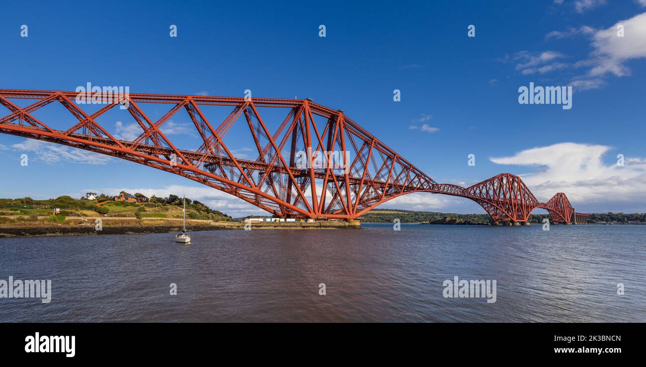 The mighty Forth rail bridge spreading across the Firth of Forth connecting north and south Queensferry in Scotland. Taken from North Queensferry. Stock Photo