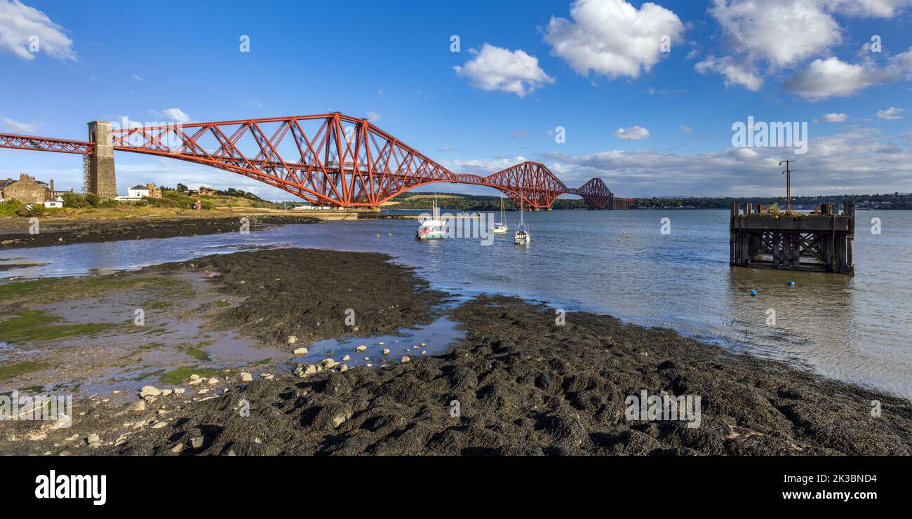 Low tide at North Queensferry Harbour, with the mighty Forth rail bridge spreading across the Firth of Forth connecting north and south Queensferry. Stock Photo