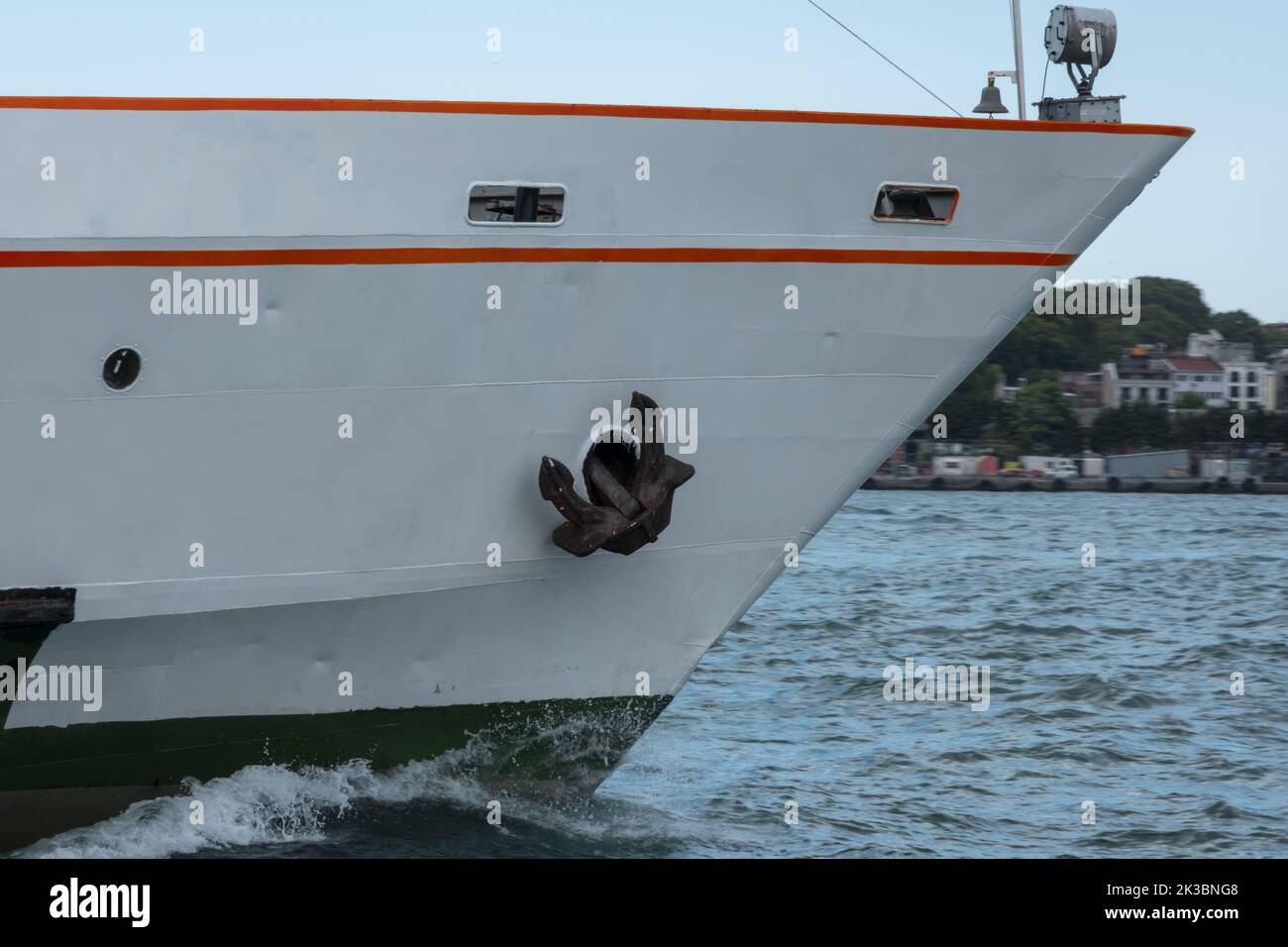 Front part of big white ship, ferry goes forward on Bosphorus with a blue sky, anchor and marine concept, keep going and progress idea Stock Photo