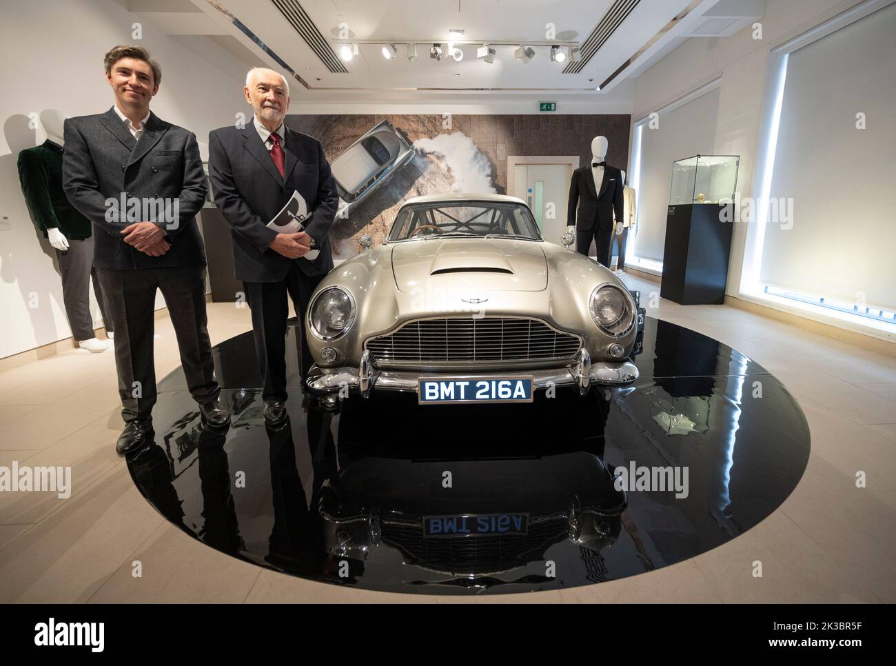 Embargoed till 11.00am, 26.9.22.  Christies, London, UK. 26 September 2022. Christie’s and EON Productions present 60 Years of James Bond, an official two-part charity sale celebrating the 60th Anniversary of James Bond on the silver screen. Featuring 60 iconic lots spanning the 25 Bond films, proceeds from the live and online auctions will be donated to benefit 45 charities. Image: Aston Martin DB5 stunt car from No Time To Die with Bond Producer Michael G Wilson and Associate Producer Gregg Wilson. Credit: Malcolm Park/Alamy Live News Stock Photo